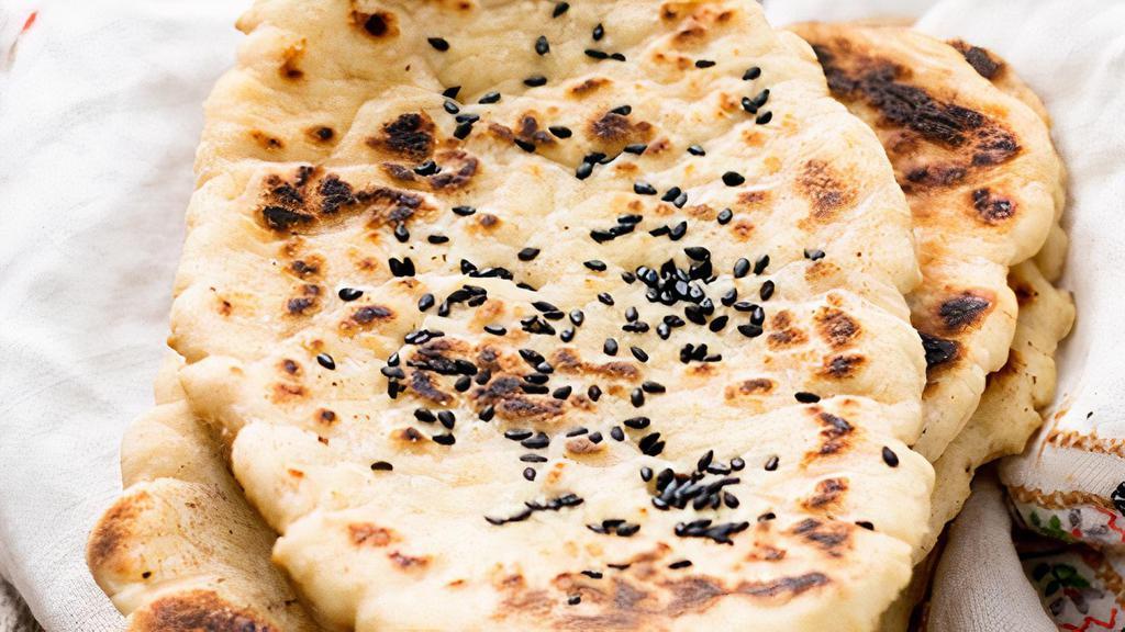 Sesame Naan (V) · Made with all-purpose white flour. White flour bread baked in tandoor topped with sesame seeds.