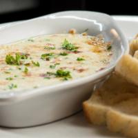 Cheese Fondue · Mozzarella cheese blended with our made-fresh-daily Alfredo sauce. Served with slices of toa...