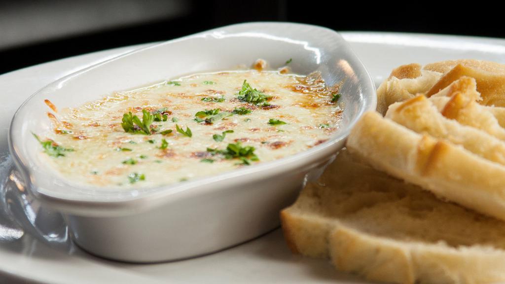 Cheese Fondue · Mozzarella cheese blended with our made-fresh-daily Alfredo sauce. Served with slices of toasted French baguette.