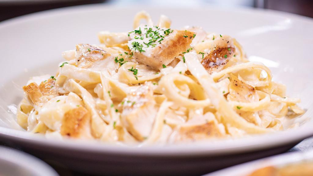 Chicken Fettuccine Alfredo ⭐️ · Tender slices of grilled chicken and fettuccine pasta tossed in our creamy, made-fresh-daily Alfredo sauce.