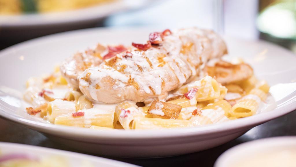 Chicken Carbonara · A grilled chicken breast sautéed with bacon and white onion, then tossed with ziti in our creamy Alfredo sauce.