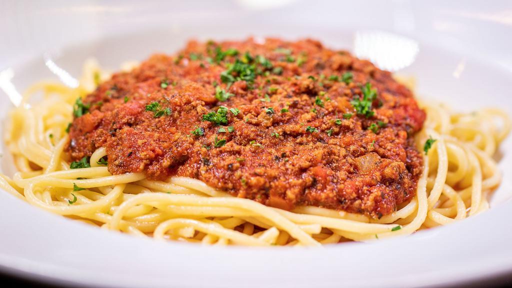 Spaghetti W/ Meat Sauce · Seasoned ground beef blended with Italian herbs and spices and our signature marinara herb sauce. Served over spaghetti.