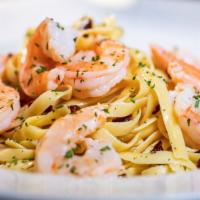 Shrimp Scampi · Shrimp sautéed in garlic butter sauce with sun-dried tomatoes and tossed with fettuccine.