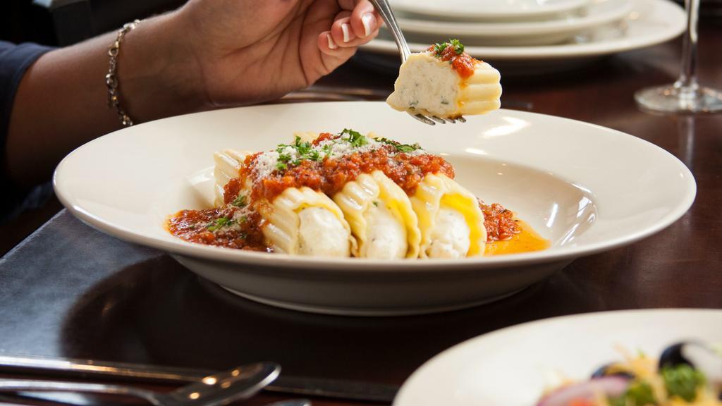 Manicotti · Manicotti stuffed with a creamy blend of ricotta and mozzarella cheeses mixed with fresh garlic and parsley, topped with traditional Italian pomodoro sauce.