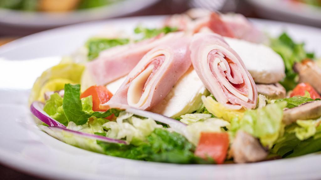 Chef Salad · Romaine and iceberg lettuce with slices of ham, salami, and provolone topped with tomatoes, mushrooms, bell pepper, red onion, black olives, and mozzarella cheese.