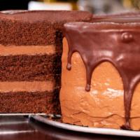 Chocolate Ganache · A moist, dark, triple-layered chocolate cake topped with homemade chocolate mousse topped wi...
