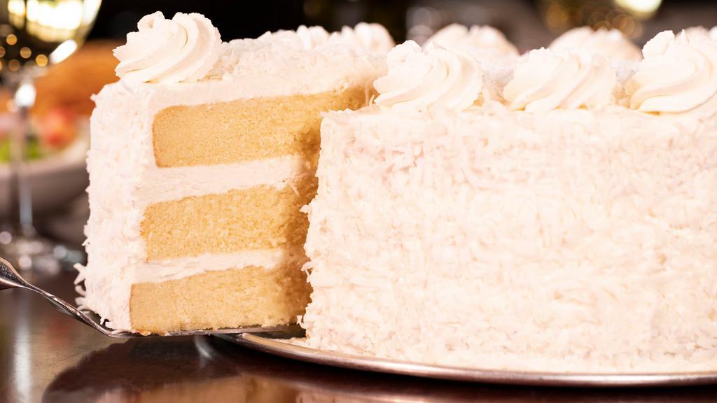 Coconut Rum Cake · Three layers of light, moist, fluffy yellow cake enhanced with the tropical flavors of real coconut rum and layered with whipped cream icing, then finished to perfection with shredded coconut.