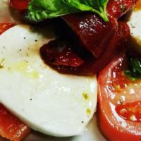 Insalata Caprese · Fresh mozzarella, Roma tomatoes, roasted peppers, chopped basil, drizzled with extra virgin ...