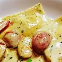 Crab Ravioli · Crab Ravioli with cherry tomatoes and asparagus tips with a creamy pesto sauce.