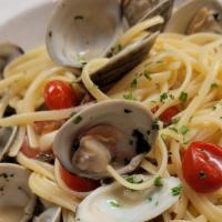 Linguine Vongole · Linguine pasta with little neck clams and tomatoes in a white wine garlic sauce.
