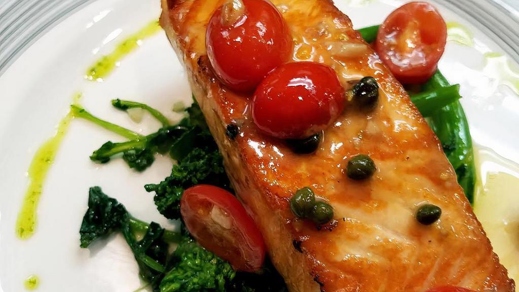 Grilled Salmon · Served with sautéed spinach, cherry tomatoes, garlic in a lemon caper sauce.
