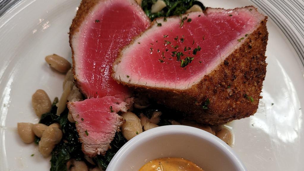 Tuna Impanato · Breaded seared tuna served rare with sautéed spinach and cannellini bens with roasted pepper aioli