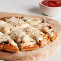 Cheesy Garlic Breadsticks · fluffy mini crust, roasted garlic spread, mozzarella blend, wild italian oregano, fresh basi...