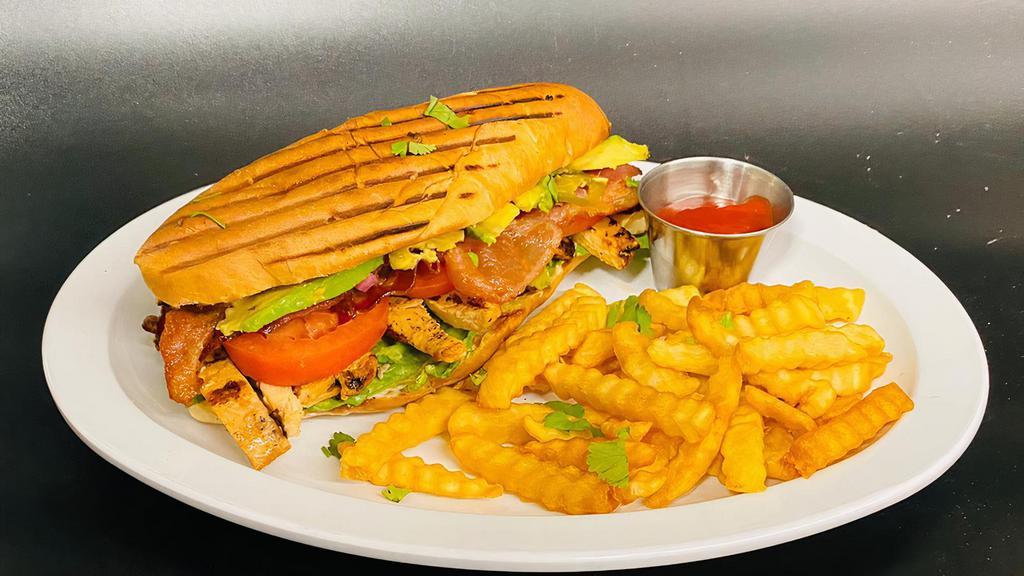 Chicken Sandwich · Pan-seared chicken served with bacon, lettuce, tomato, onions, mayonnaise, avocado, and French fries. Homemade bread.