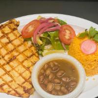 Pollo A La Plancha · Marinated grilled chicken served with rice, beans, and garden salad.