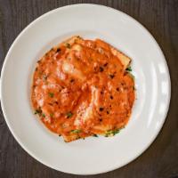 Lobster Ravioli · Fresh home-made ravioli filled with lobster meat. Served in a shallot tomato cream sauce.