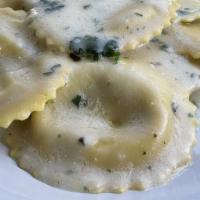 Ravioli Porcini And Truffle · Ravioli filled with Porcini Mushrooms and White Truffle, served in a Butter and Parmesan che...