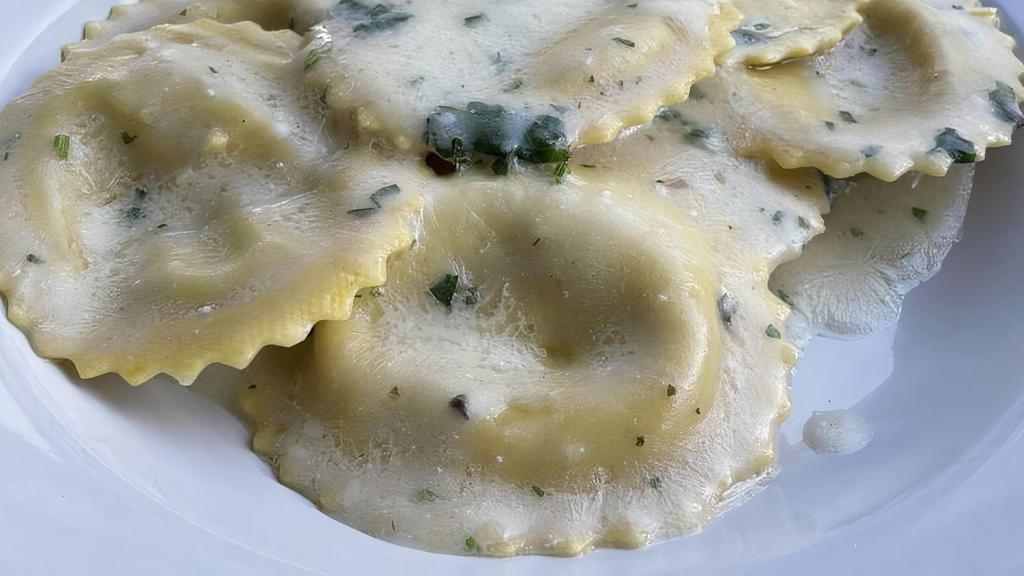 Ravioli Porcini And Truffle · Ravioli filled with Porcini Mushrooms and White Truffle, served in a Butter and Parmesan cheese sauce .