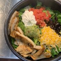 Keto Chicken Salad · Grilled fajita chicken On top of a bed of lettuce, with olives, tomatoes, sour, Shredded che...