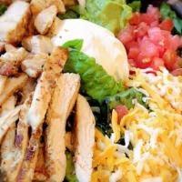 Chicken Avocado Salad  · Grilled chicken breast, romaine lettuce, grilled corn, avocado,
tomatoes and  shredded chees...