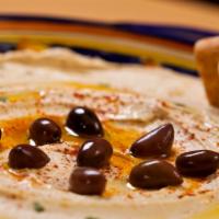 Hummus · Vegan. Our signature recipe of puréed chickpeas, tahini, lemon, and garlic.
