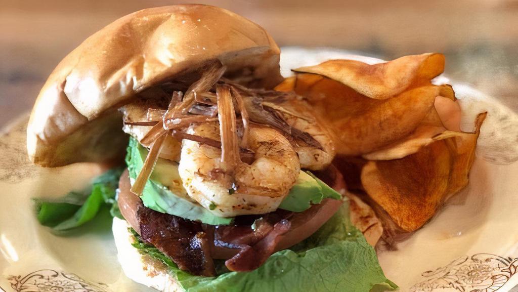 Shrimp Blt · Surf seasoned grilled shrimp topped with fried leeks over crisp bacon, avocado, lettuce, tomato in a toasted brioche bun served with house cut chips