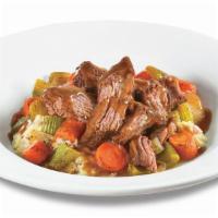Family Pot Roast Dinner  · Slow Cooked Pot Roast atop red skinned mashed potatoes with roasted carrots, celery and onio...