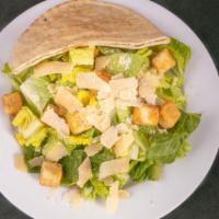 Caesar Salad · Romaine lettuce, croutons, Parmesan cheese, Caesar dressing and pita bread.