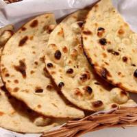 Tandoori Roti  · Whole wheat flat bread baked to perfection in an Indian clay oven