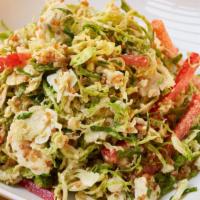 Shaved Brussels Sprouts Salad · crunchy quinoa, red pepper, blue cheese & dijon vin