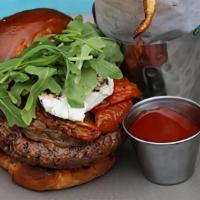 The Impossible Autograph · Plant Based Burger, Caramelized Onions, Oven Roasted Tomatoes, Arugula, Goat Cheese (D,G))