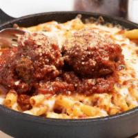 Baked Ziti And Meatballs · Two large balls served over delicious baked ziti, side salad, and garlic bread.
