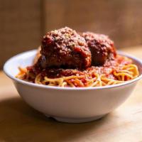 Spagetti & Meatball · Two large balls served over a generous portion of spaghetti, red sauce, side salad, and garl...