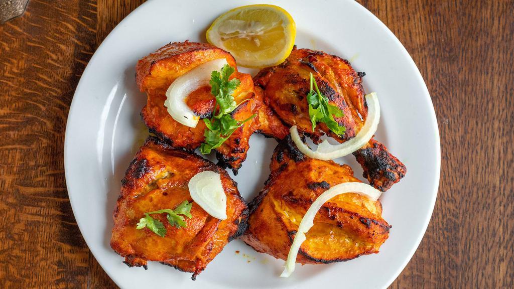 Chicken Tandoori · Half chicken marinated in a mixture of yogurt, garlic, ginger and other select spices and grilled in the tandoor. Served with basmati rice.