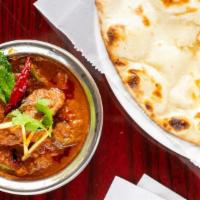 Goat Curry · Boneless meat cooked with fresh tomato, onion and spice flavored sauce.