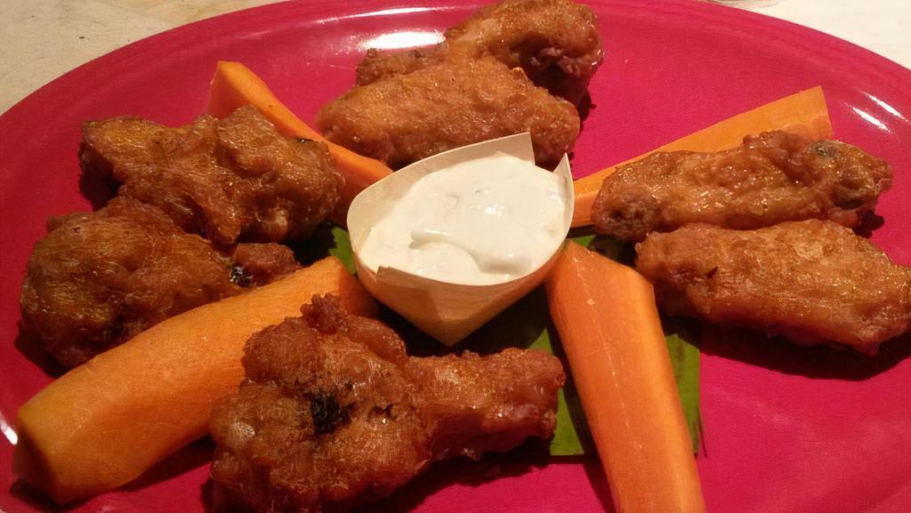 Caribbean Wings · 8 caribbean seasoned wings served dry with carrots and celery.