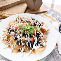 Chorizo Nachos · Grilled traditional spicy Mexican sausage.