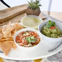 Trio 'N Chips · Our homemade tortilla chips served with our guacamole, salsa verde, and pico de gallo.
