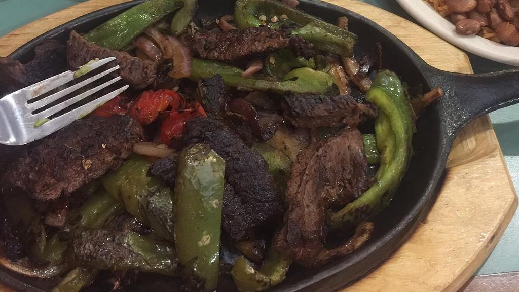Bistec / Steak Fajita · Green peppers, red peppers and onions. Served with rice and beans.