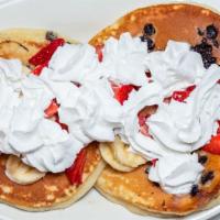 Mix Fruit Pancakes · Three pieces with butter and syrup.