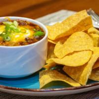 Beef Chili Bowl & Chips · Beef Chili topped with Sour Cream, Cheddar Cheese, and Green Onions. Served with a side of T...