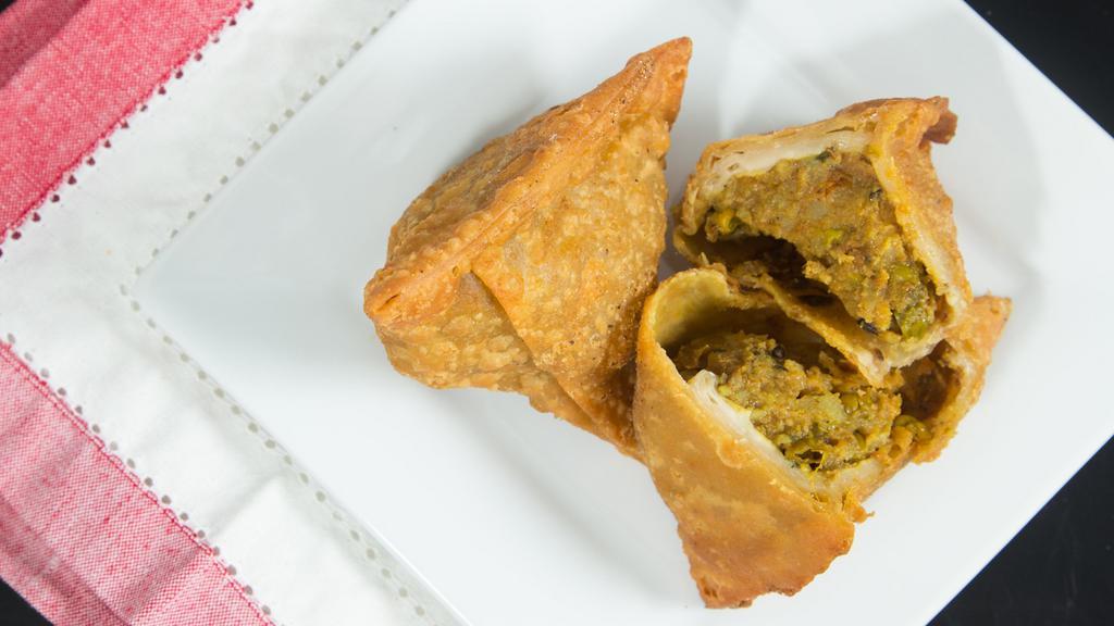 Vegetable Samosas · Lightly spiced potatoes and peas wrapped in pastry dough and deep fried. * 
 
*2 Per order