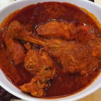 Chicken Vindaloo · Chunks of boneless chicken and potatoes cooked in a spicy red chili, onion and vinegar sauce.