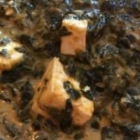 Palak Paneer · Spinach cooked in a blend of flavored spices with homemade cubes of cheese.