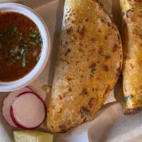 Birria · [SAUCY][GF] TWO Cheesy pan-fried tacos with Stewed beef + Cilantro & onions + Consommé on th...