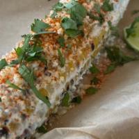 Elote · Grilled corn on the cob slathered in a mixture of  crema, chili-lime powder and cotija chees...