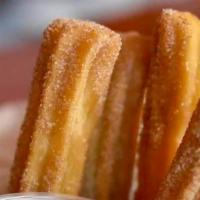 Churros · Sticks of fried-dough pastry served with dulce de leche.