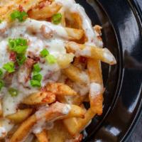 Mega Fries · Fries topped with whiz, mozzarella, bacon & a side of ranch dressing.