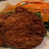 Vitello Milanese · Breaded veal cutlet with arugula salad, cherry tomatoes, red onions, and carrots with lemon ...