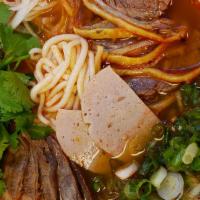 Spicy Beef Soup · Thick rice noodles with slices of flank, beef heel muscle and pork ham.